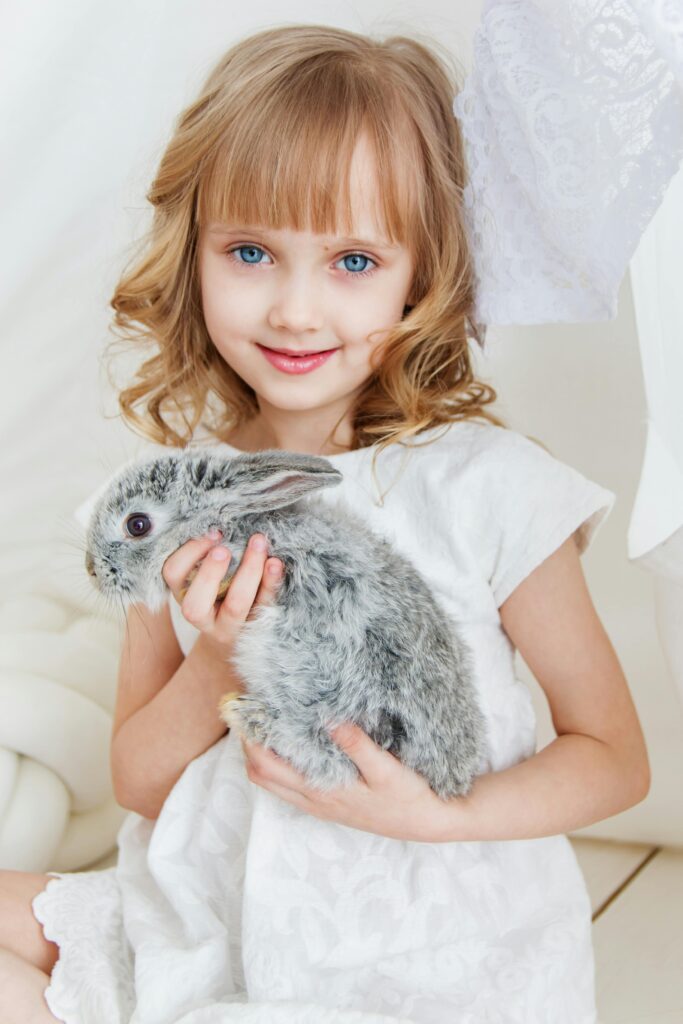 child with rabbit in it's hands